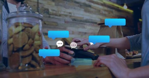 Contactless card payment at rustic cafe counter, barista holding pos, chat bubble overlay