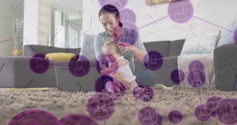 Mother adjusting infant while bonding on plush rug in living room with network overlay