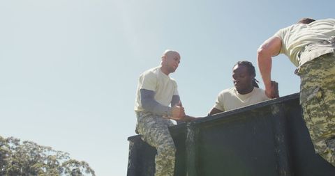 Three Soldiers Assisting on Army Obstacle Course - Download Free Stock Images Pikwizard.com