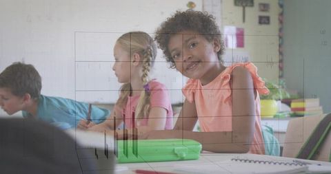 Happy Young Student Learning in a Busy Classroom