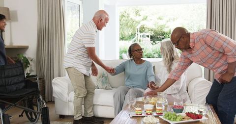 Multiracial Family and Caregivers Enjoying Time in Living Room
