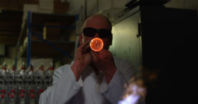 Glassblower Wearing Protective Gear Shaping Molten Glass - Download Free Stock Images Pikwizard.com