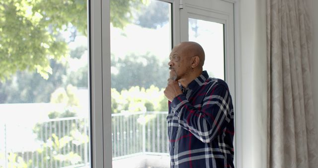 Senior Man Reflecting while Looking out Window - Download Free Stock Images Pikwizard.com