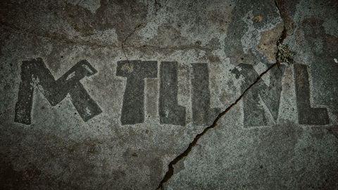 Rugged concrete graffiti on cracked urban surface