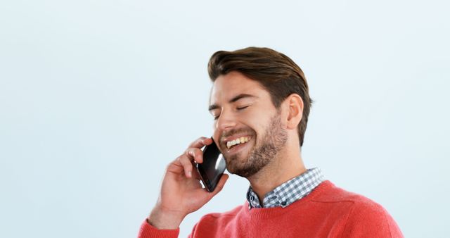 Smiling Man Talking on Smartphone in Red Sweater and Checkered Shirt - Download Free Stock Images Pikwizard.com