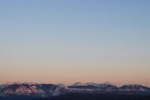 Peaceful sunrise over snow-capped mountain range - Download Free Stock Photos Pikwizard.com
