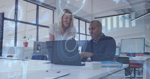 Collaborating team using laptop with futuristic HUD overlay in modern open-plan office