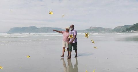 Senior Couple Enjoying Relaxing Walk Along Scenic Beach