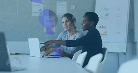 Business Colleagues Analyzing Data on Laptops in Modern Office