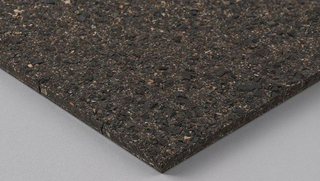Dark recycled rubber composite slab with speckled granular texture and beveled edge