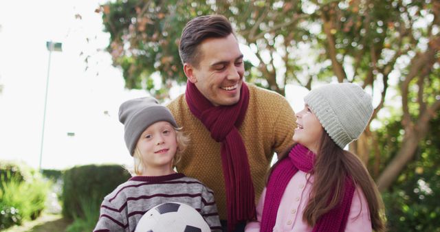 Smiling father enjoying outdoor family time with children - Download Free Stock Images Pikwizard.com