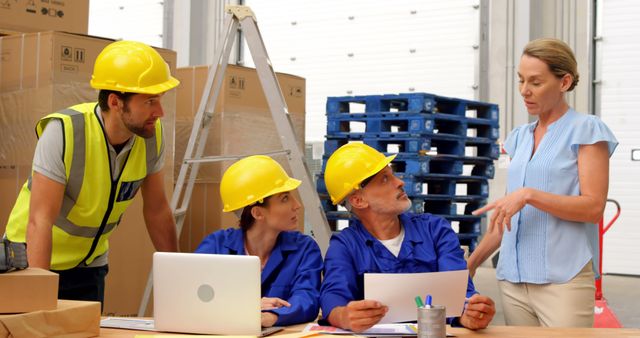 Warehouse Team Discussing Work Plan Around Laptop - Download Free Stock Images Pikwizard.com