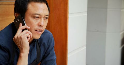 Asian Man Having Serious Phone Call Intently Focused - Download Free Stock Images Pikwizard.com