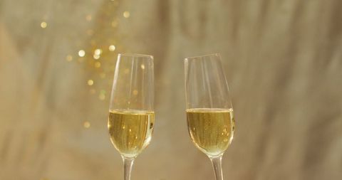 Elegant Champagne Toast with Gold Confetti Backdrop