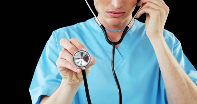 Surgeon in Blue Scrubs Examining with Stethoscope Against Black Background - Download Free Stock Images Pikwizard.com