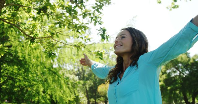 Happy woman enjoying nature in sunny park - Download Free Stock Images Pikwizard.com