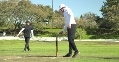 Cricketer Bowling on Sunny Day During Exciting Match