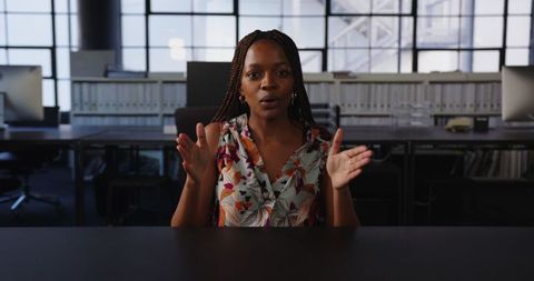 Confident Female Leader Engaging Enthusiastically in Office Discussion
