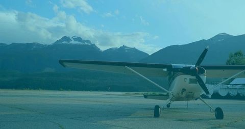 Single-engine propeller airplane on mountain runway