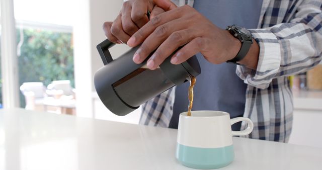 Person Pouring Freshly Brewed Coffee from French Press into Ceramic Mug - Download Free Stock Images Pikwizard.com