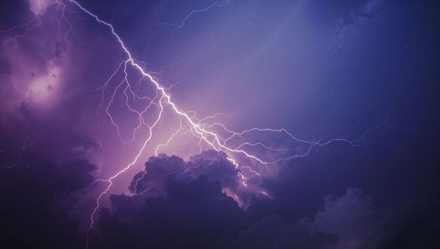 Dramatic Lightning Bolt Illuminating Purple Night Sky