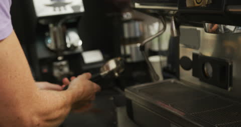 Barista Preparing Coffee Using Espresso Machine in Cafe