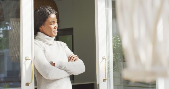 Woman stands by open door looking outside thoughtfully - Download Free Stock Images Pikwizard.com