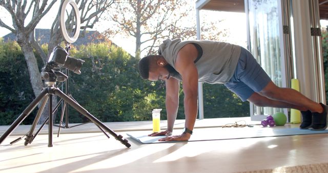 Man Doing Push-Ups in Home Gym Recording Fitness Video - Download Free Stock Images Pikwizard.com