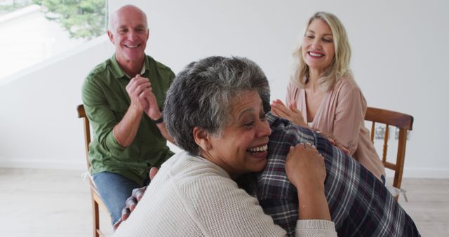 Elderly Friends Laughing and Embracing in Bright Room - Download Free Stock Images Pikwizard.com