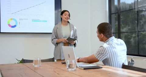 Business Professional GivingPresentation in Modern Office