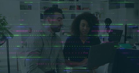 Collaborating Coworkers Using Laptop in Modern Office