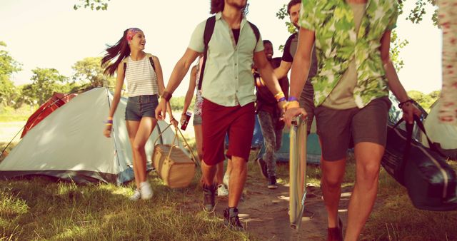 A group of young adults in casual wear enjoys a camping trip or summer festival outdoors. - Download Free Stock Photos Pikwizard.com