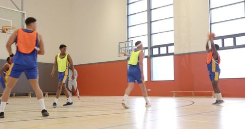 Diverse Basketball Players Shooting in Indoor Gym