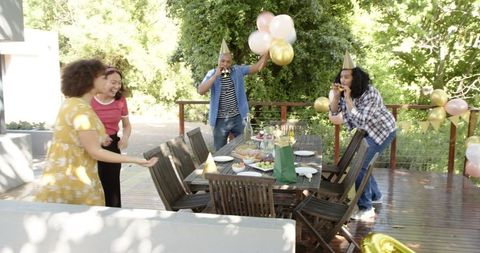Diverse Friends Joyfully Celebrating Outdoor Birthday Party
