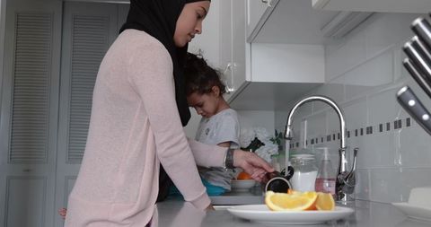 Mother and Daughter Bonding During Kitchen Routine