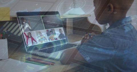 Child attending virtual classroom on laptop with pencils at desk and futuristic hud overlay