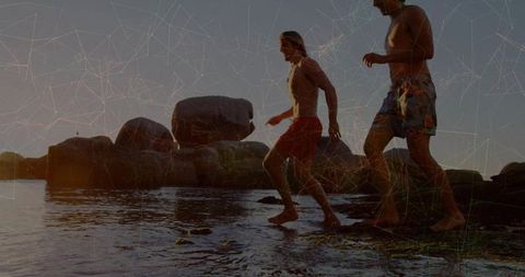 Friends Enjoying Coastal Adventure at Sunny Beach Sunset