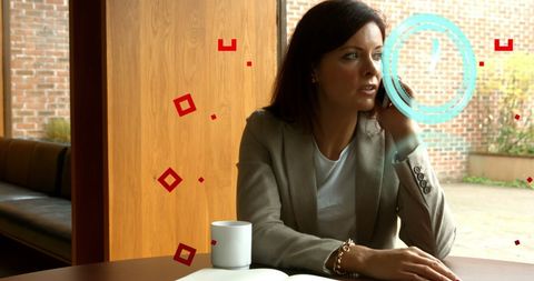 Businesswoman Engaged on Smartphone Call by Office Window