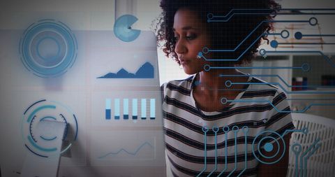 Businesswoman Analyzing Digital Financial Data at Desk