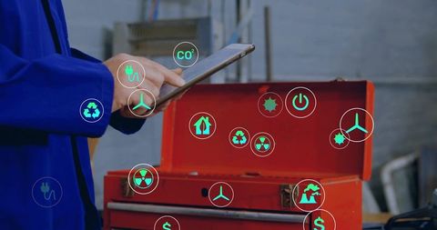 Technician holding tablet tapping screen displaying ar icons over red tool chest
