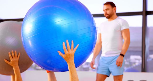 Fitness Instructor Leading Exercise Ball Class - Download Free Stock Images Pikwizard.com