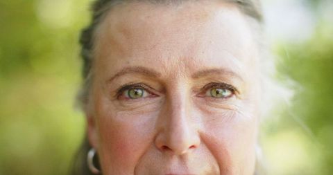 Middle-Aged Woman with Green Eyes Relaxing in Nature - Download Free Stock Images Pikwizard.com