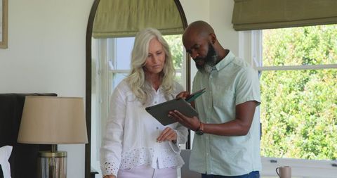 Couple Collaborating With Technology Indoors