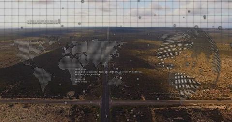 Long straight highway running through arid landscape with digital world map overlay