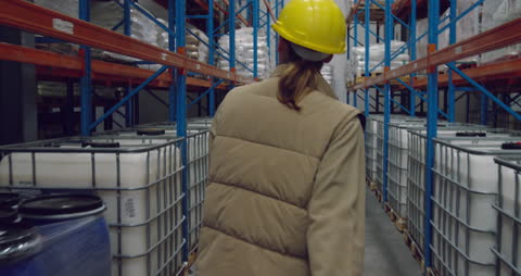 Warehouse Worker Organizing Inventory Aisles