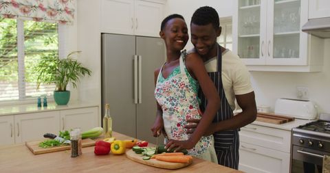 Happy Couple Cooking Together in Bright Modern Kitchen