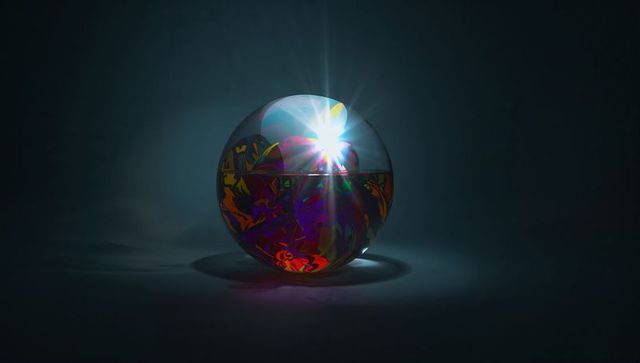 Glowing reflective glass sphere showing vivid marbling and starburst light flare