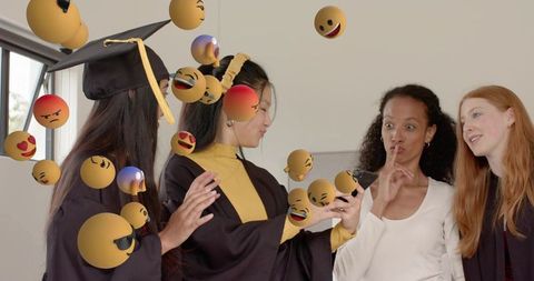 Graduates celebrating with floating emojis, smartphone selfie, friendship and digital joy