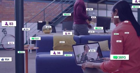 Remote team collaborating with live social engagement metrics on laptop in open office
