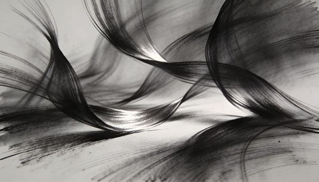 Monochrome charcoal brushstrokes flowing gestural abstract texture with high contrast motion